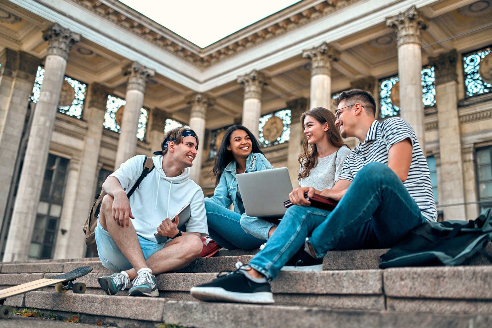 International students studying together on university campus steps